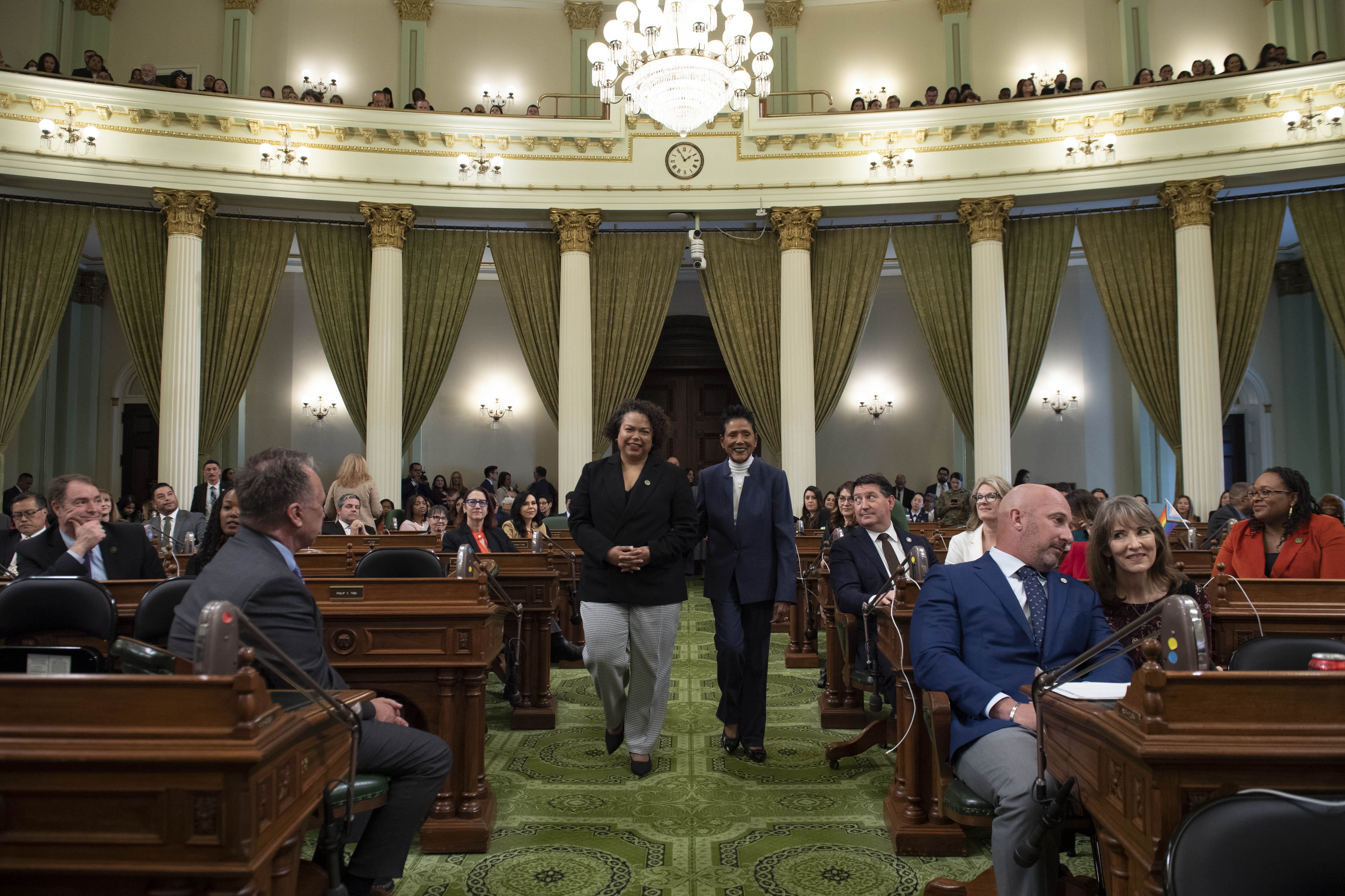 Assemblymember Bonta and Elaine Brown walk down the Assembly floor