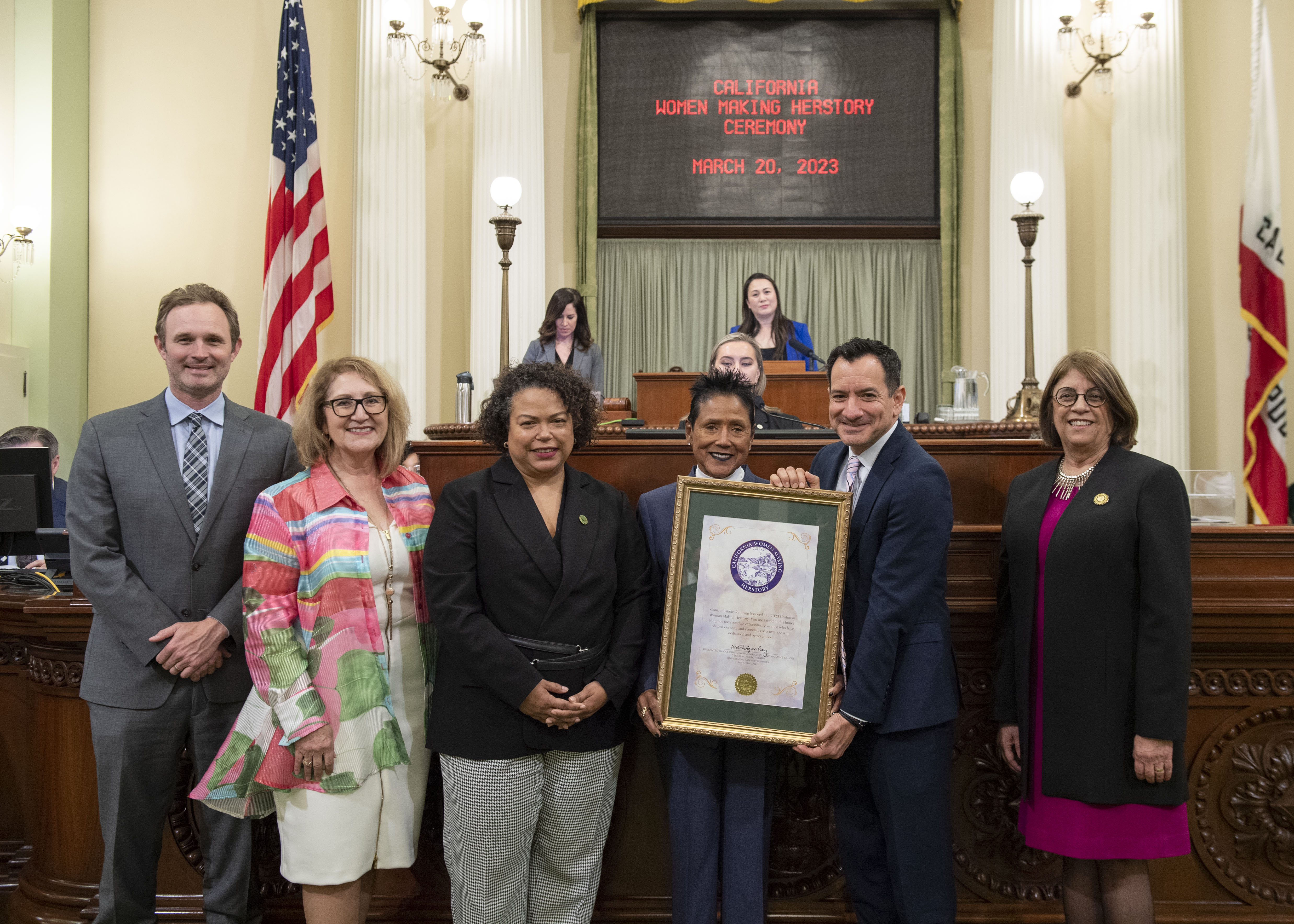 Elaine Brown on the Assembly floor with Assemblymember Bonta, Aguiar-Curry, Rendon, Gallagher and Reyes